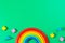 Baby kids toy background. Wooden stacking rainbow and colorful blocks on light green background. Top view