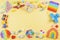 Baby kids toys background with educational wooden toys, train, plane, pop it fidget toys on yellow background. Top view