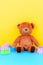 Baby kids toys background with teddy bear and colorful building blocks bricks