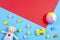 Baby kids toys background. Wooden cars, colorful bricks and soft toys on blue and red color background