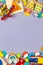 Baby kids toys frame. Colorful educational wooden plastic and fluffy toys for children on gray background. Top view