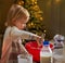 Baby kneading dough in christmas decorated kitchen