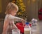 Baby kneading dough in christmas decorated kitchen