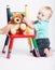 Baby Kneeling with Teddy Bear on Chair