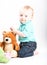 Baby Kneeling with Teddy Bear On White