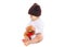 Baby in knitted brown hat with teddy bear toy sitting on white