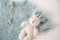 Baby knitted suit in blue and bunny toy