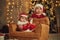 Baby is on the little sofa. Two kids in Santa hats are celebrating holidays indoors together