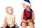 Baby looking at the sibling sister in Santa\'s hat