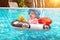 Baby love to swim. Summer vacation at sea. A little girl less than one year old is driving an inflatable boat in the shape of a