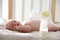 Baby lying in cot, focus on breast pump with milk