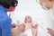 Baby lying on his back as his doctor examines him during a standard medical checkup