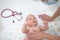 Baby lying on his back as his doctor examines him during a standard medical checkup