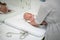 Baby lying on his back being messured during a standard medical checkup.