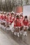 Baby majorettes marching wrapped up against rain at Carnival parade