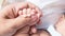 Baby and mamy hold his hand with love