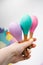 Baby maracas in hand with yellow manicure. Toys made of natural wood.