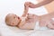 Baby massage. Massagist massaging and doing gymnastic to little kid