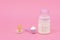 Baby milk formula feeding bottle, pacifier on a pastel pink background