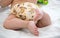 Baby in modern eco stacks of cloth diapers and replacement bushings selective focus close-up on bright background, little cute foo