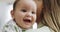 Baby, mother and smile of a happy child at home while playing, bonding and curious. Face of infant kid and a young woman