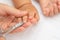 Baby nail cut. Hand with scissors trims the fingernails of the sleeping baby. Selective focus