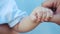 Baby newborn holding a dad hand. kid dream concept. close-up baby hand grabs the finger of the father hand. newborn baby