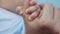 Baby newborn holding a mom hand. kid dream concept. close-up baby hand grabs the finger of the mother hand. newborn baby