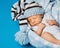Baby newborn portrait, kid sleeping in blue hat