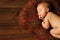 Baby newborn portrait, kid sleeping on brown