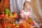 Baby next to a basket of apples
