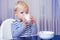 Baby nutrition. Eat healthy. Toddler having snack. Healthy nutrition. Drink milk. Child hold glass of milk. Kid cute boy