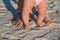 Baby and parent feet on sand beach