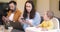 Baby and parents busy in a digital gadgets during a lunch at home