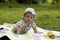 Baby on the picnic carpet in grass