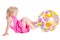 Baby in pink dress playing with coloful ball