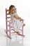 Baby on pink rocking chair