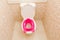 Baby pink toilet seat in toilet. Hygiene. Children`s toilet. Children`s pad, cover, toilet seat. The child goes to an adult toil