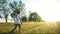 baby pinwheel. little girl silhouette plays with windmill toy wind in the park. happy family childhood dream concept