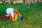 Baby playing with a colorful wooden rainbow on the grass, children`s intellectual and mental development