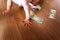 Baby playing with some dollar bills he has found on the floor of his house, eating money