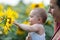 Baby playing with sunflower