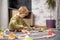 Baby playing with toy railroad, trains and cars on the floor