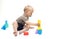 Baby playing with toys on a white background. A funny little child plays with colorful cubes