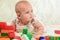 Baby plays with building bricks.