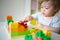 Baby plays in the constructor. small child builds a castle out of blocks. concept of development of fine motor skills
