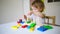 Baby plays in the constructor. small child builds a castle out of blocks. concept of development of fine motor skills