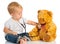 Baby plays in doctor toy bear, stethoscope