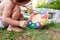 A baby plays with an entertaining didactic activity in the garden of his house in summer