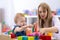 Baby plays with mother or teacher in nursery